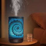 Diffusore aromatico nero con spirale illuminato con luce blu e vapore.